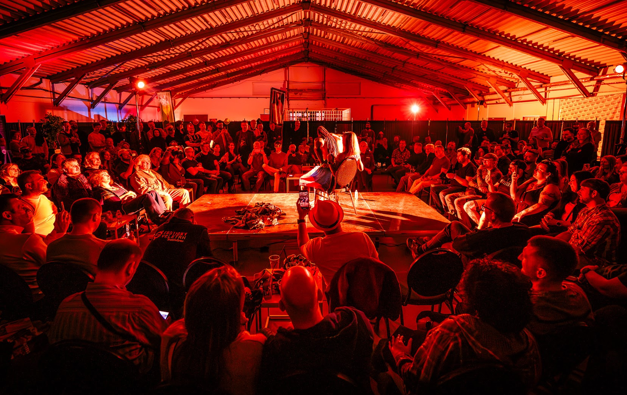 Maskovaní performeři při show v temné kulise zóny Alterno Chambers